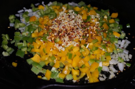 Heat oil and add bell peppers, onions, garlic and chile pepper