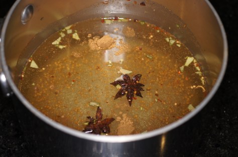 Add spices, water an vinegar to a medium saucepan
