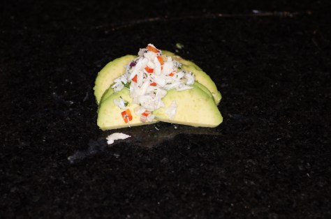 Place crab salad in the middle of avocado