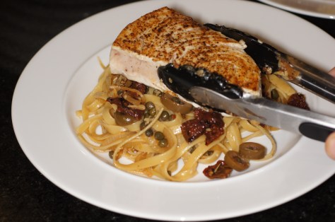 Place swordfish steak on top of pasta