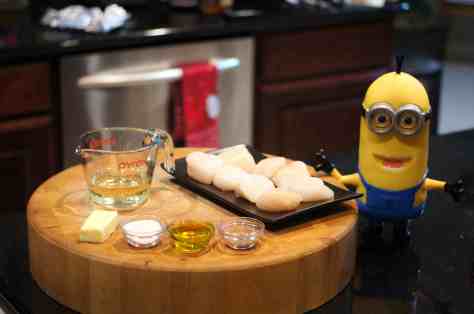 © 2013 REMCooks.com - Baby Lady loves the little minions from "Despicable Me." She has been wanting her own personal minion. So, she bought Tim and insisted he help with dinner. 
