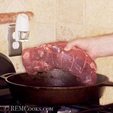 nicely tied roast going into a beautifully seasoned cast iron skillet - another post